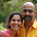 A happy couple smiling in their garden.